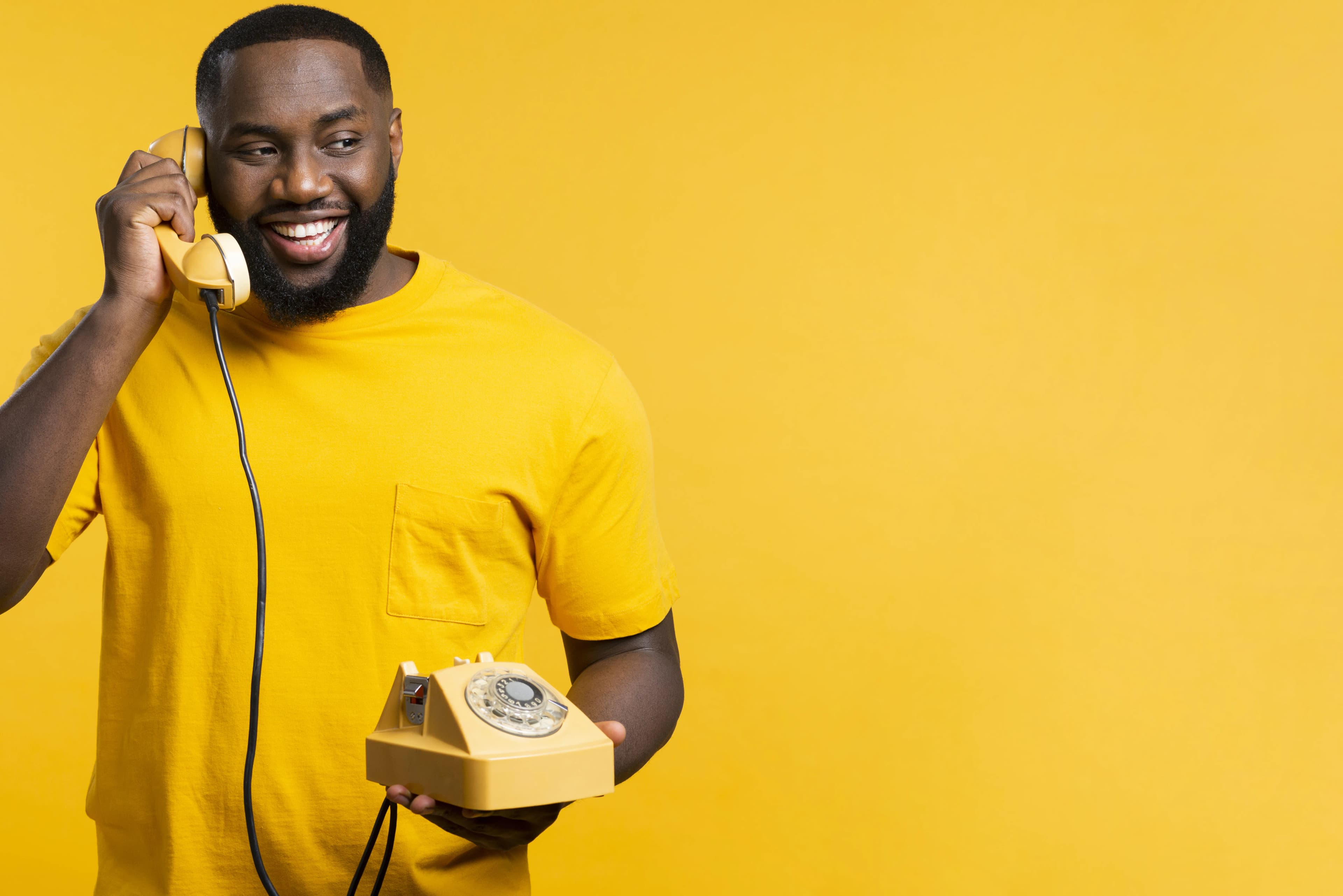 Smiley man with an old phone